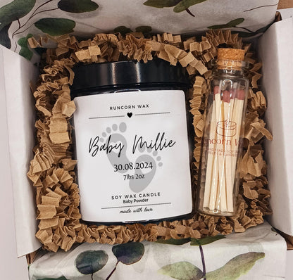 Personalized candle and matches set in a decorative box with ruffled brown baby birth congratulations paper.