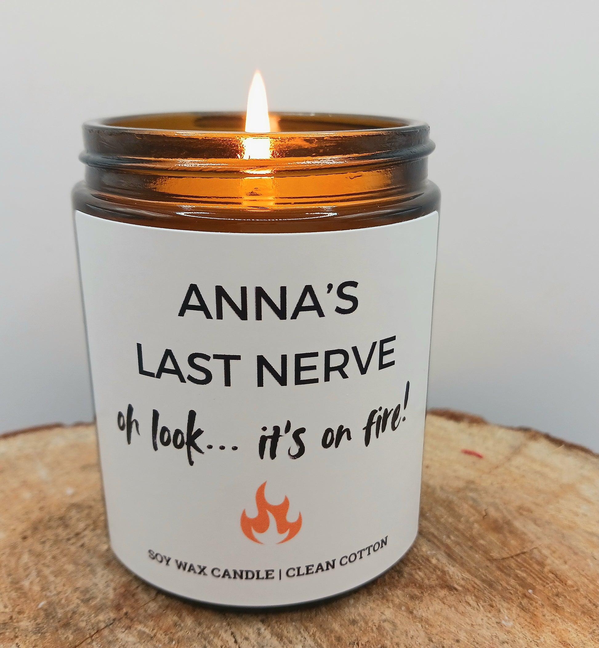 Candle with a humorous label and a small bottle of matches in the background funny last nerve on fire candle gift friend birthday present