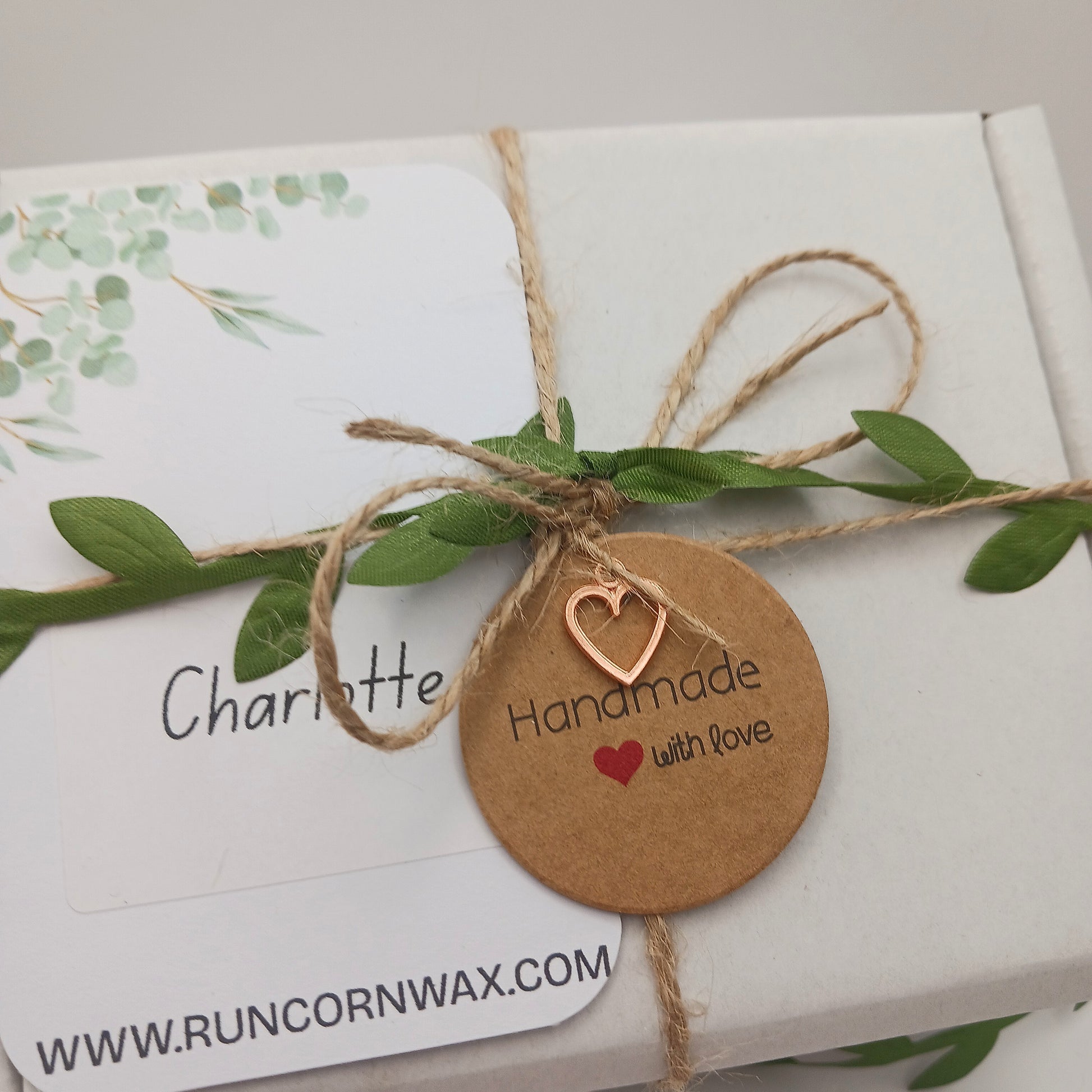 Gift box with a 'Handmade with Love' tag and greenery, featuring the brand 'Runcorn Wax'.