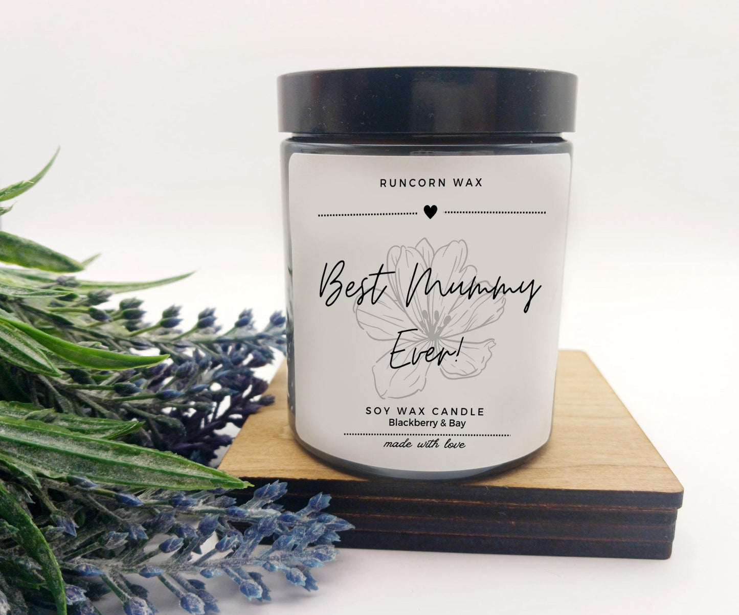 Candle labeled 'Best Mummy Ever!' with lavender on a white background