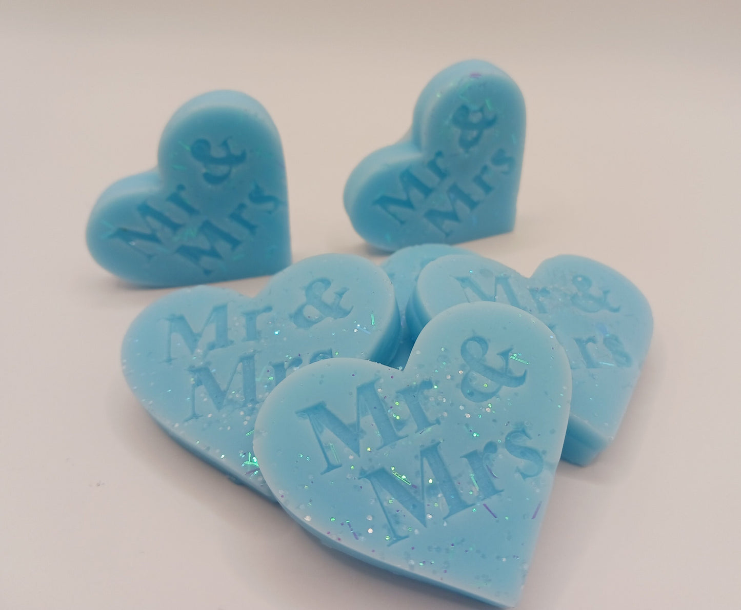 Blue heart-shaped candies with 'Mr & Mrs' text on a white background