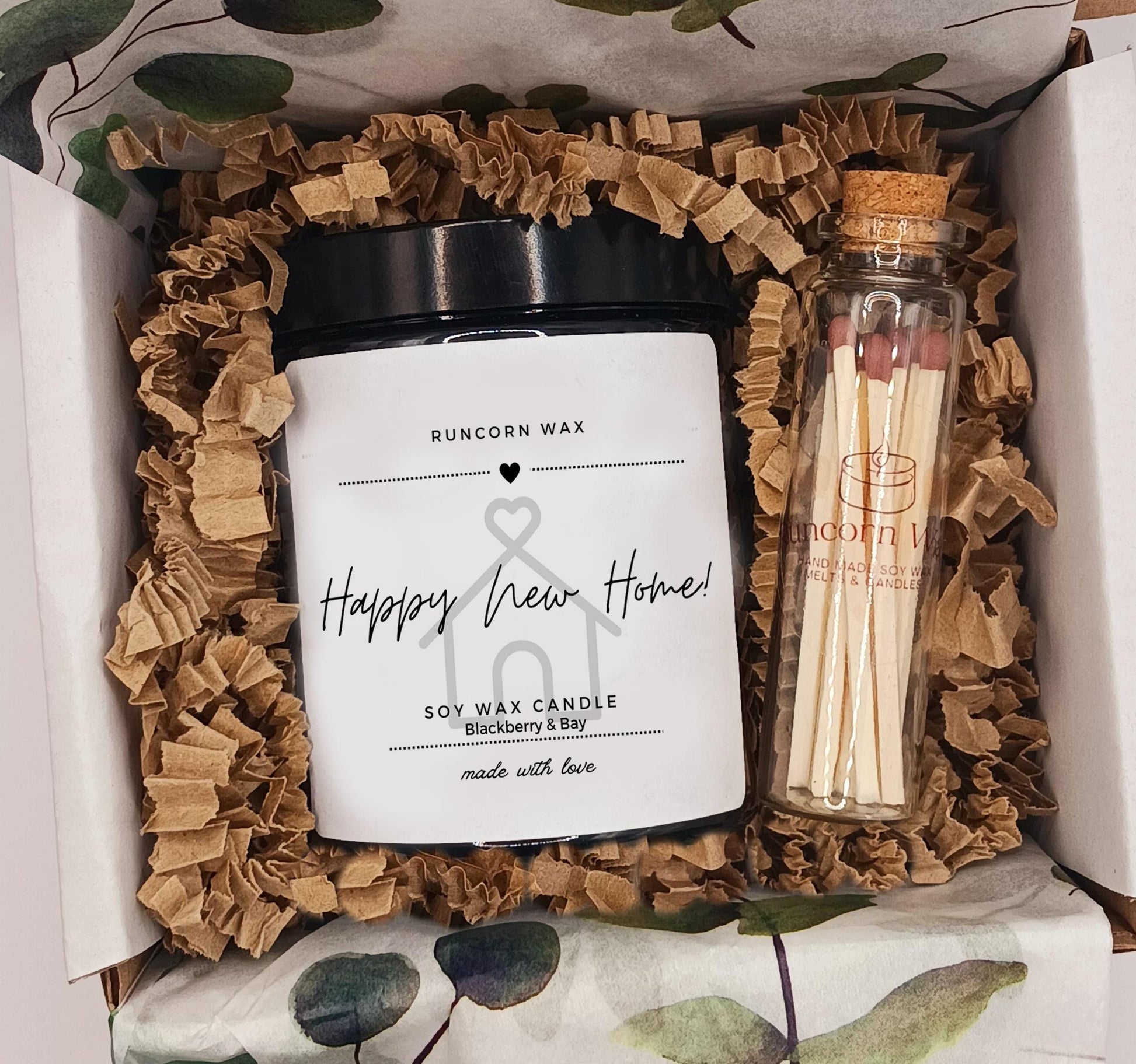 Candle and matches set in a decorative box with ruffled brown paper happy new home