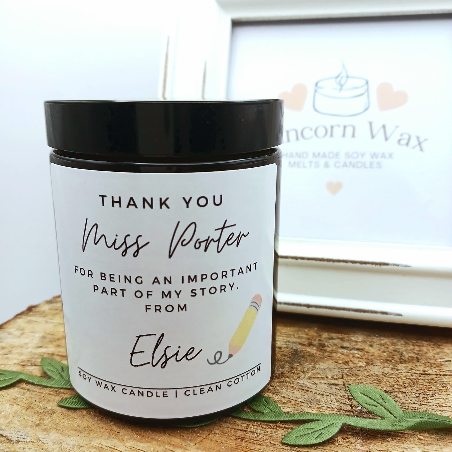 Personalized candle with a message on a wooden surface, branded 'Runcorn Wax'.