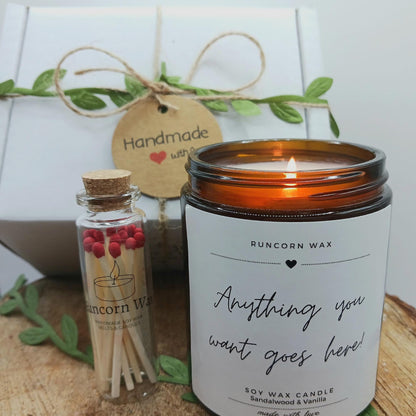 Runcorn Wax candle and matches with a decorative tag on a wooden surface