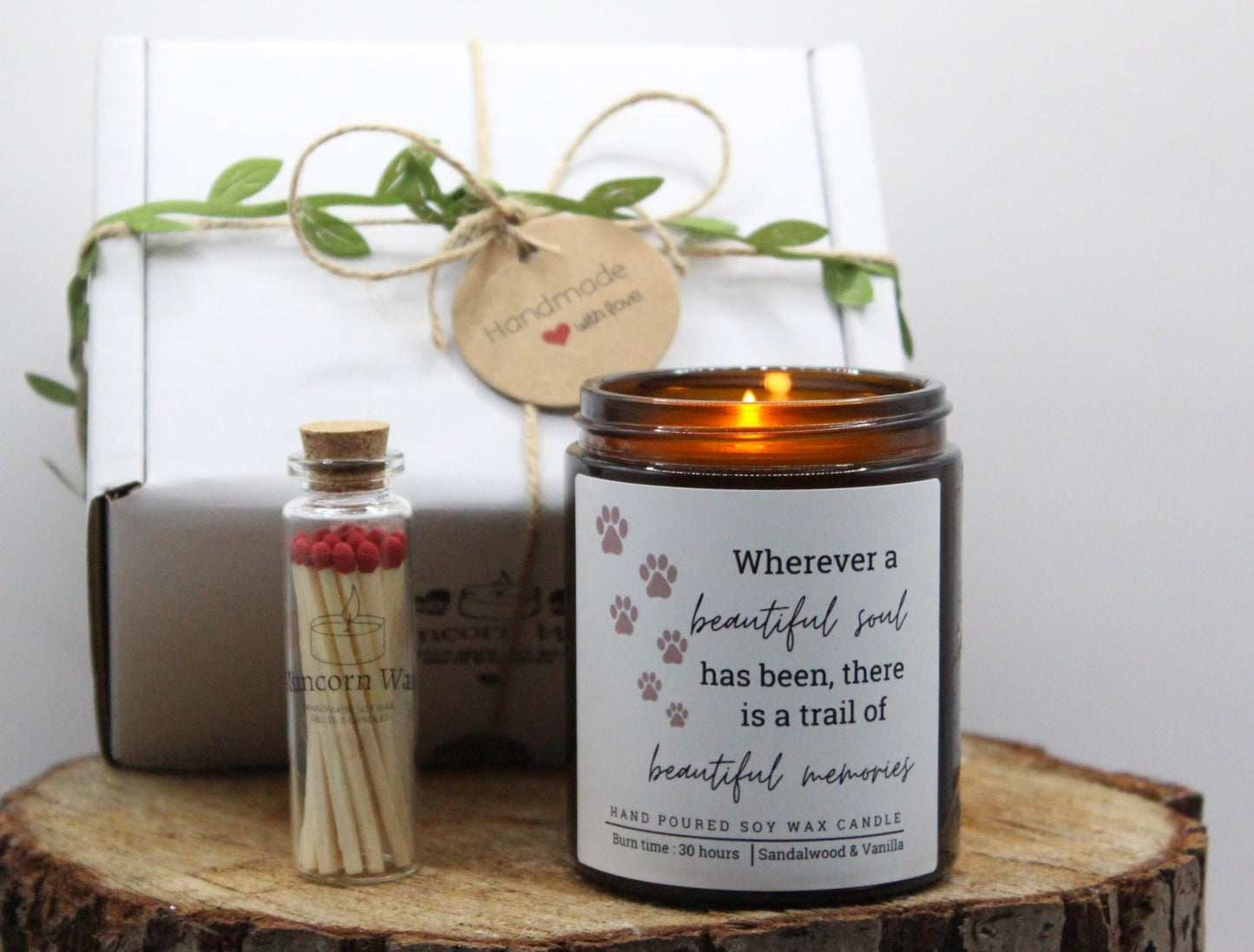 Candle with a quote and matches on a wooden surface pet bereavement memorial
