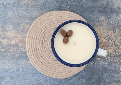 Blue mug with coffee beans on a textured surface