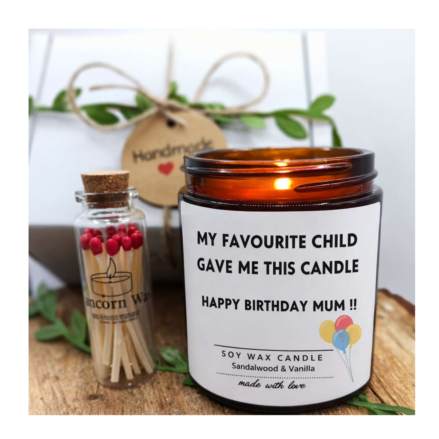 Candle with a personalized message and a small bottle of matches on a wooden surface. my favourite child gave me this candle