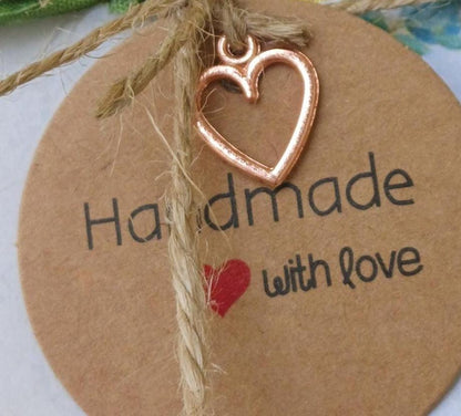 Round brown tag with heart-shaped charm and 'Handmade with love' text