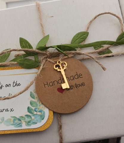 Round brown tag with gold key charm and 'Handmade with love' text on a white background.