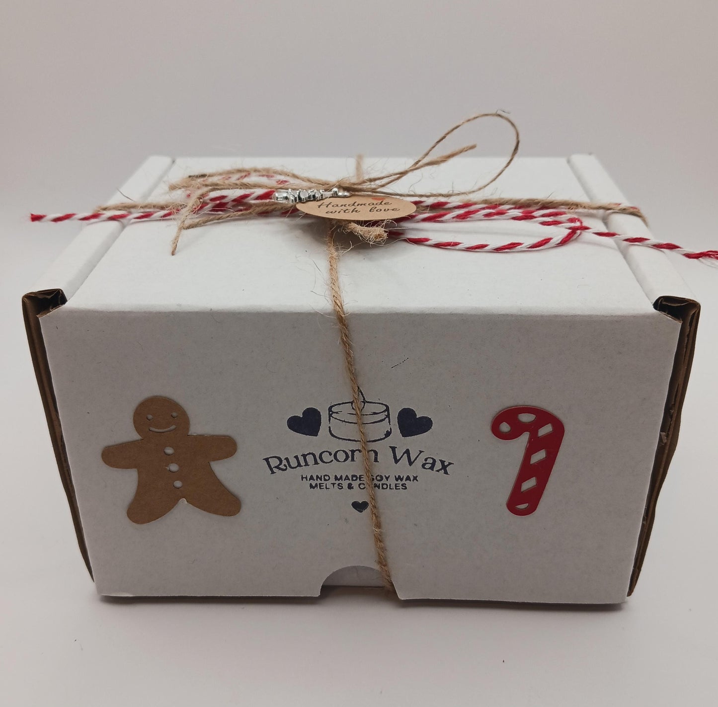 White box with Runcorn Wax branding, gingerbread man, candy cane, and heart designs on a white background.