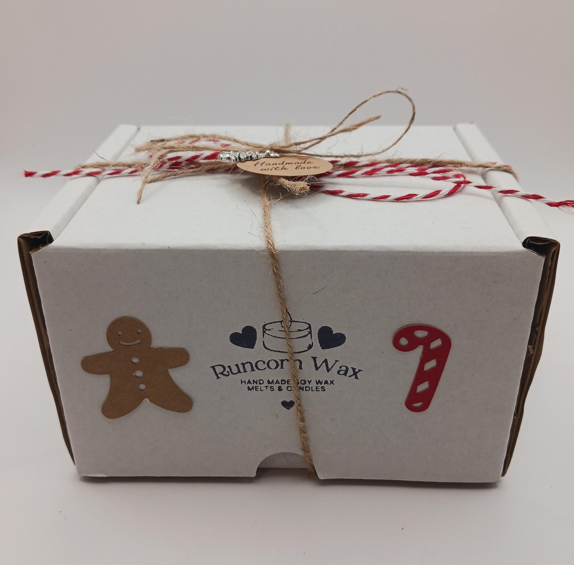 White box with Runcorn Wax branding, gingerbread man, candy cane, and heart designs on a white background.
